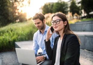 a-young-businessman-with-laptop-and-businesswoman-HV6QAPS.jpg