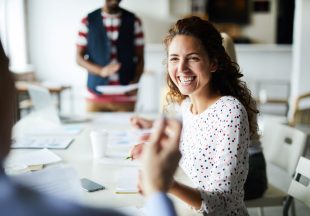 happy-businesswoman-at-meeting-YSNV8BJ.jpg